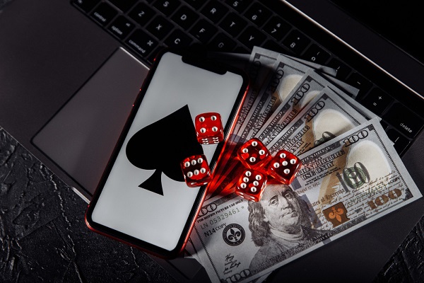 Dice, smartphone and dollar banknotes on keyboard.